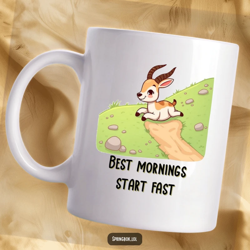 Funny springbok mug featuring a gleeful springbok sliding down a grassy hill on its belly, captured mid-laugh.
