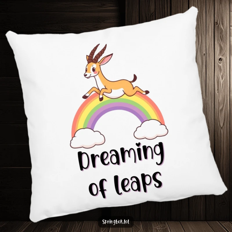 Funny pillow showcasing a springbok leaping over a colorful rainbow, adding soft comfort and whimsical charm to any room.