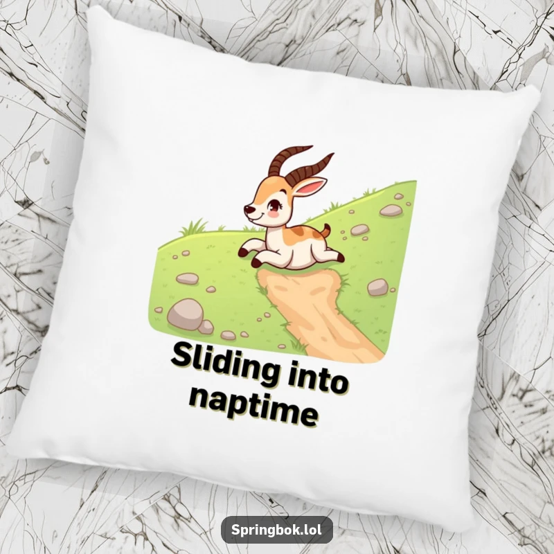 Funny springbok decorative pillow with a happy springbok sliding down a grassy hill on its belly, bringing cozy humor.