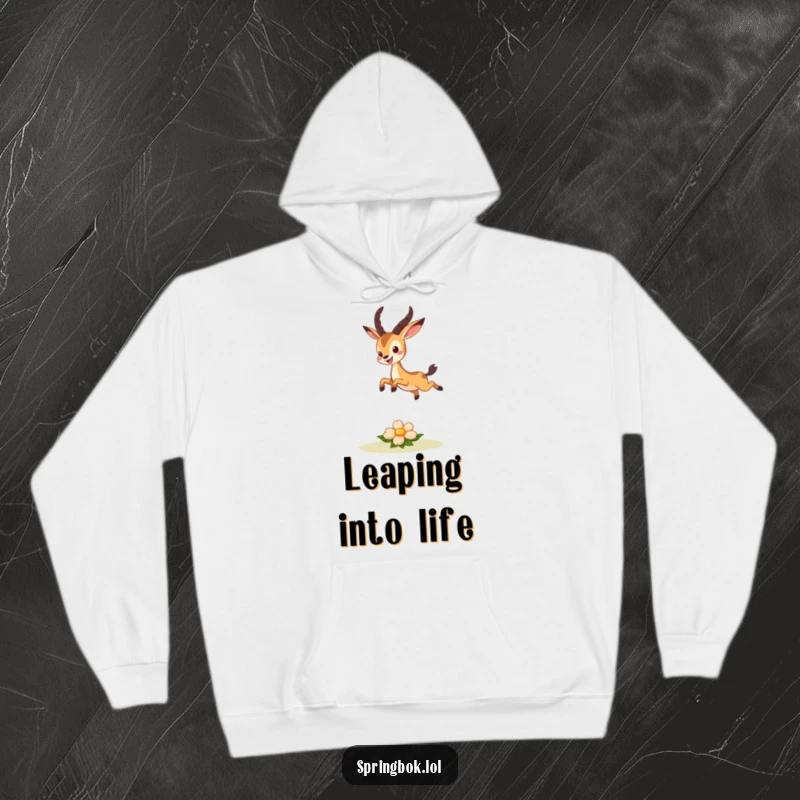 Funny hoodie depicting a cute springbok character leaping joyfully over a small, smiling flower, radiating pure happiness.