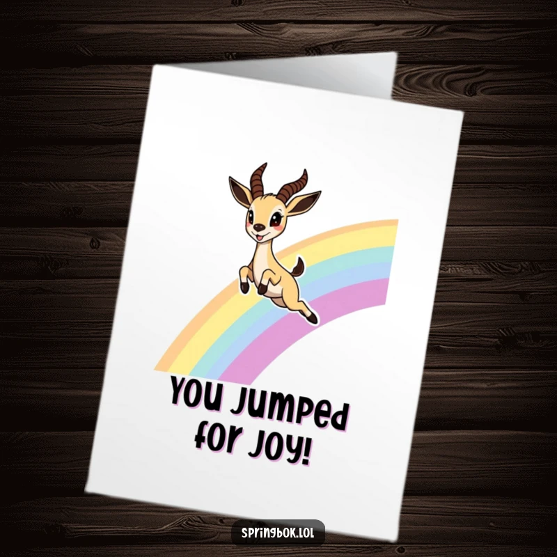 Funny Free Printable Congratulations Card of a cute springbok leaping joyfully over a rainbow, eyes wide with excitement.