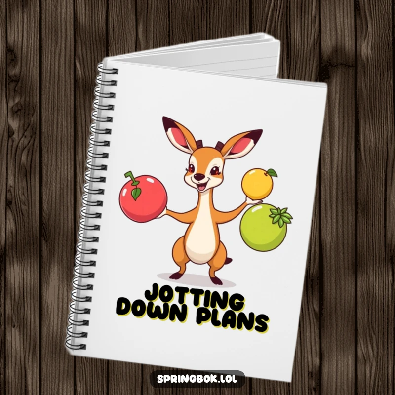Funny springbok juggling colorful fruits with enthusiasm, printed on a notebook for capturing creative thoughts.