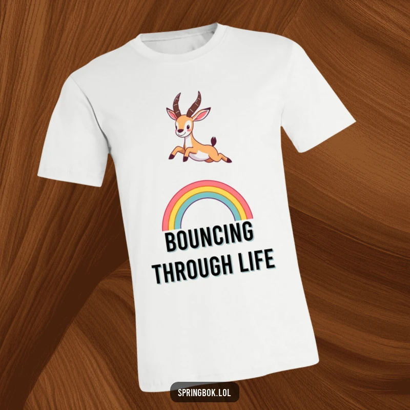 Funny t-shirt featuring a cute springbok leaping energetically over a colorful, stylized rainbow arc, full of motion and cheer.