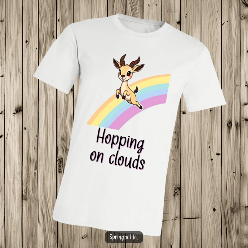 Funny Springbok Rainbow T-Shirt, showing a cute springbok leaping joyfully over a rainbow with wide, delighted eyes, perfect for cheerful individuals.