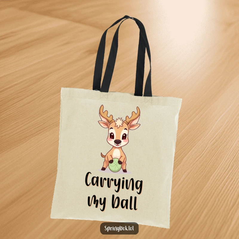 Funny Antelope Tote Bag: A grinning antelope is captured mid-bounce, using its nose to playfully control a small ball, radiating joy.